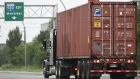 A transport truck pulls a freight container in Montreal. Canada recorded a goods trade deficit of C$2.28 billion in March, with exports falling 5.3%.