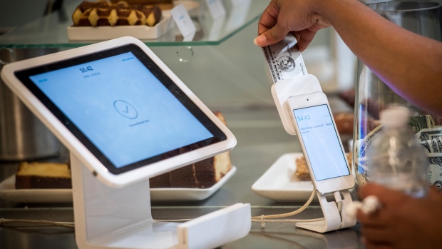 A customer removes a credit card into Square Inc. device while making a payment in San Francisco.
