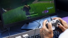 An attendee plays in the Epic Games Inc. Fortnite: Battle Royale Celebrity Pro Am on the sidelines of the E3 Electronic Entertainment Expo in Los Angeles, California, U.S., in Los Angeles, California, U.S., on Tuesday, June 12, 2018. 
