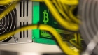 A bitcoin logo sits on a LL 1800W power unit supplying cryptocurrency mining machines at the SberBit mining \'hotel\' in Moscow, Russia, on Saturday, Dec. 9, 2017. Futures on the world’s most popular cryptocurrency surged as much as 26 percent in their debut session on Cboe Global Markets Inc.\'s exchange, triggering two temporary trading halts designed to calm the market. 