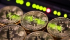 Stacks of bitcoins sit near green lights on a data cable terminal inside a communications room at an office in this arranged photograph in London, U.K., 