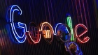 The Google Inc. logo hangs illuminated at the company's exhibition stand at the Dmexco digital marketing conference in Cologne, Germany, on Wednesday, Sept. 14, 2016. 