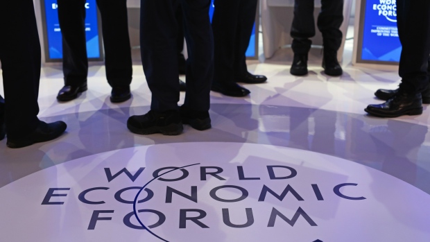 A WEF logo sits on the stage as panelists talk ahead of a panel session at the World Economic Forum (WEF) in Davos, Switzerland. 