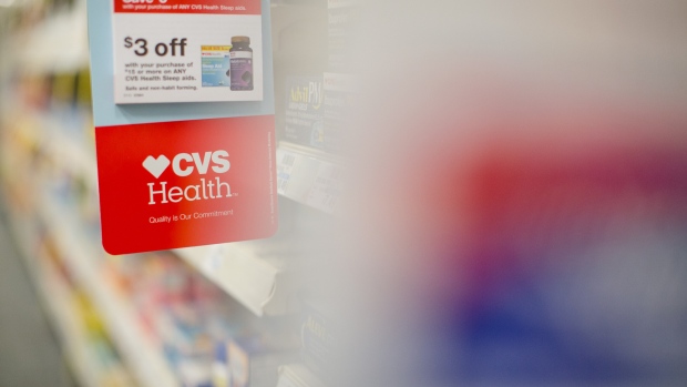 Signage is displayed in an aisle of a CVS Health Corp. store in downtown Los Angeles, California, U.S., on Friday, Oct. 27, 2017.