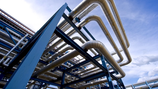 Pipes carry water, steam and oil at Devon Energy Corp.'s 35,000 barrel per day Jackfish Projects plant, where Steam Assisted Gravity Drainage (SAGD) is used to extract bitumen from oil sands, near Conklin, Alberta, Canada. 