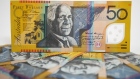 Australian fifty dollar banknotes are arranged for a photograph in Australia.  
