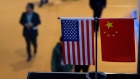 Chinese and US flag at a booth during the first China International Import Expo (CIIE) in Shanghai. 