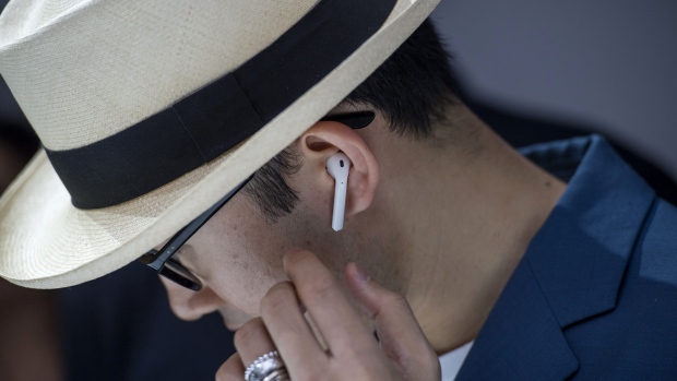 An attendee wears the Apple Inc. AirPod wireless headphones during an event in San Francisco, California, U.S., on Wednesday, Sept. 7, 2016.