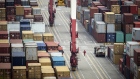 A worker walks past shipping containers sitting stacked at the Yangshan Deepwater Port, operated by Shanghai International Port Group Co. (SIPG), in Shanghai, China, on Friday, May 10, 2019. The U.S. hiked tariffs on more than $200 billion in goods from China on Friday in the most dramatic step yet of President Donald Trump's push to extract trade concessions, deepening a conflict that has roiled financial markets and cast a shadow over the global economy. 