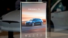 A sign for a Tesla Model 3 sedan is seen at a Tesla showroom in Washington, DC, on August 8, 2018. 