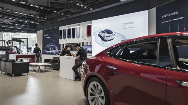 Tesla Motors Inc. electric vehicles sit on display at the company's showroom in Shanghai, China, on Tuesday, Sept. 12, 2017. China will consider granting foreign investors more access into its electric-vehicle market as the world’s biggest market for battery-powered automobiles comes out with new policy initiatives to give a fillip to the industry. 