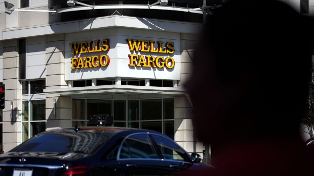 Cars drive past a Wells Fargo & Co. bank branch in Los Angeles. 