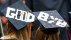Two graduates display a farewell message on their mortarboards during Syracuse University's commencement ceremony at the Carrier Dome in Syracuse, New York, U.S., on Sunday, May 16, 2010. Students entering one of the weakest job markets in history need to have the courage to speak the truth, "even when it's unpopular," JPMorgan Chase & Co. Chief Executive Officer Jamie Dimon told graduates. 
