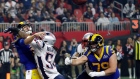 New England Patriots' Dont'a Hightower (54) hits Los Angeles Rams' Jared Goff, left, as he throws a 