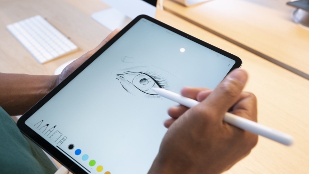 An Apple Inc. employee demonstrates a drawing program on an iPad tablet at the Apple Carnegie Library flagship store in Washington, D.C. 