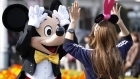 The Walt Disney Co. character Mickey Mouse greets a visitor at Tokyo Disneyland, operated by Oriental Land Co., in Urayasu city, Chia prefecture, Japan, on Friday, April 15, 2011. 