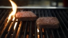 Impossible Burger plant based meat cooks on a grill during the Impossible Foods Inc. grocery store p