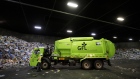 A GFL Environmental Inc. garbage truck prepares to drop off a load of waste at a transfer station in
