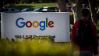 A pedestrian walks past signage at Google Inc. headquarters in Mountain View, California. 
