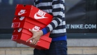 A customer carries boxes of Nike Inc. shoes outside of the NikeTown Los Angeles retail store in Beverly Hills, California, U.S., on Sunday, March 20, 2016.  