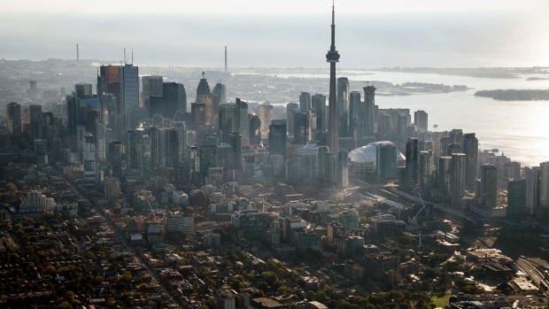 The CN Tower stands among buildings in the downtown skyline in this aerial photograph taken above Toronto, Ontario, Canada. 