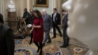 GETTY IMAGES - Mitch McConnell walks with staff and security as he arrives at the U.S. Capitol on Ja
