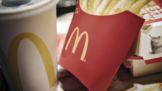 A McDonald's logo is displayed on a box of French fries inside one of the company's restaurants in Shanghai. Photographer: Qilai Shen/Bloomberg