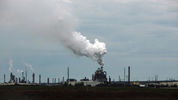Steam rises from a Syncrude Canada Ltd. facility in the Athabasca oil sands north of Fort McMurray, Alberta, Canada, on Friday, June 14, 2019. Once the booming heart of the country's energy industry, the little city of 75,000 in northeastern Alberta has become a showcase for the debt troubles many Canadians are facing. Photographer: Amber Bracken/Bloomberg
