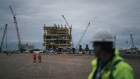 Employee pass in front of the finished Abkatun-A2 oil platform at the Mcdermott International Inc. fabrication facility in Altamira, Tamaulipas state, Mexico, on Friday, Nov. 2, 2018. 