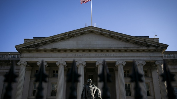 An American flag flies above the U.S. Treasury building in Washington. Photographer: Al Drago/Bloomberg
