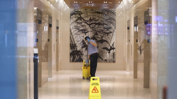 A worker cleans an office tower lobby in Toronto, Ontario, Canada, on Wednesday, March 25, 2020. The unemployment rate in Ontario, which accounts for almost 40% of Canada's output, was running at close to a record low before the province ordered all but essential businesses to shut down in a bid to contain the virus. Ontario now sees zero growth for this year. Photographer: Cole Burston/Bloomberg