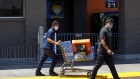 Shoppers wearing protective masks leave a Walmart store in Lakewood, California, U.S., on Thursday, July 16, 2020.