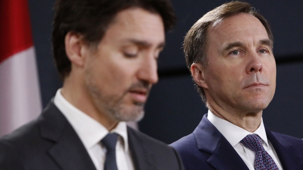 Bill Morneau, shown alongside Justin Trudeau in March 2020, resigned as finance minister amid a public disagreement with the prime minister.