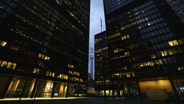 Office towers light up in the evening in the financial district of Toronto, Ontario, Canada, on Friday, May 22, 2020. Photographer: Cole Burston/Bloomberg