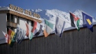 International flags wave on top of the Davos Congress Center