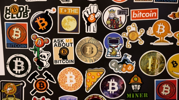 Novelty crypto stickers inside a cryptocurrency exchange in Barcelona, Spain, on Tuesday, Dec. 5, 2023. Bitcoin shrugged off a slide in global markets during a rally to a more than 19-month high, a sign of its decoupling from other assets.