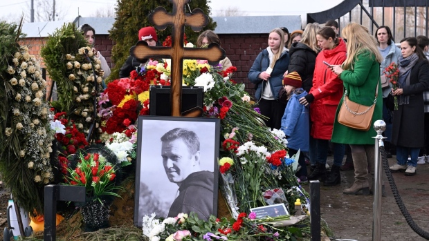 People pay tribute at the grave of Alexei Navalny in Moscow on March 17. Photographer: Natalia Kolesnikova/AFP/Getty Images