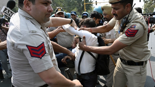 <p>Police officers remove a demonstrator blocking traffic during a protest against the arrest of Delhi Chief Minister Arvind Kejriwal in Delhi, on March 22.</p>