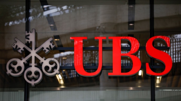 The UBS Group AG logo at their offices in the City of London, UK, on Monday, March 20, 2023. European stocks slumped on Monday, as UBS's agreement to buy Credit Suisse Group AG failed to assuage fears about potential global banking turmoil. Photographer: Jason Alden/Bloomberg