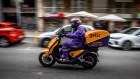 <p>A courier for the food delivery service Getir rides along a street in Barcelona, Spain.</p>