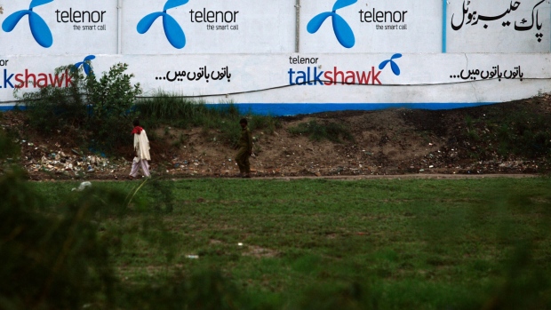 A advert for Telenor Pakistan Ltd. on a field in Matiari, Pakistan. Photographer: Asim Hafeez/Bloomberg
