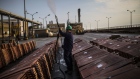 An employee sprays anti-oxidant solution on a pile of copper plates at the Southern Copper Corp. refinery in Ilo, Peru, on Thursday, Jan. 26, 2017. Peru posted its biggest trade surplus in five years in December, as rising copper output and higher prices boosted exports. The South American country last year overtook China to became the world's biggest copper producer after Chile, allowing it to record its first annual trade surplus in three years. Photographer: Dado Galdieri/Bloomberg