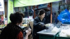 A customer buys tofu at a food stall in the Moraenae Market ahead of Lunar New Year in Jeonju, Jeollabuk Province, South Korea, on Thursday, Feb. 8, 2024. South Korea’s inflation slowed in January more than expected to a range sought by policymakers, but they remain wary of a potential resurgence in price growth due to global conflicts that could spur energy costs. Photographer: SeongJoon Cho/Bloomberg
