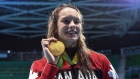 Penny Oleksiak celebrates gold in the 100m freestyle swim