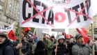 Protesters march against trade deals with Canada and the U.S. in Warsaw, Poland, Saturday, Oct. 15.