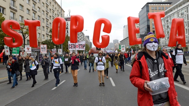 Protesters march against trade deals with Canada and the U.S. in Warsaw, Poland, Saturday, Oct. 15. 
