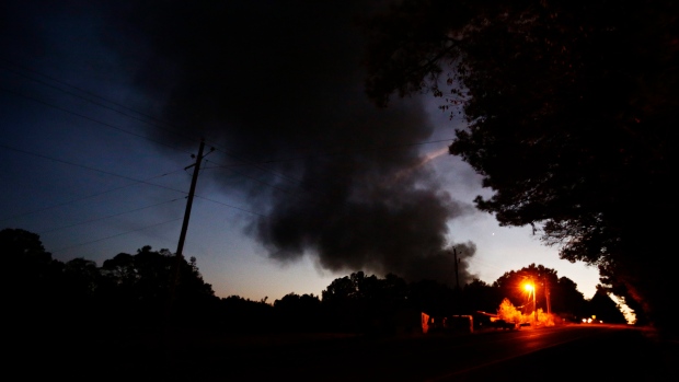 A house near a plume of smoke from a Colonial Pipeline explosion, in Helena, Ala.