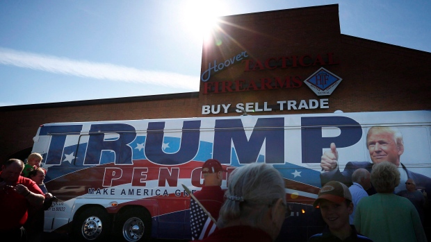 Supporters stand near Republican presidential candidate Donald Trump's bus