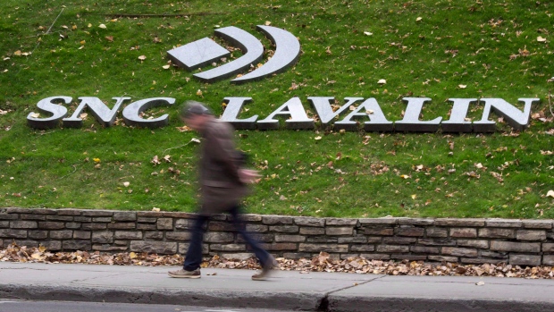 A man walks past the headquarters of SNC-Lavalin in Montreal