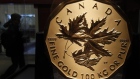 A visitor to the Royal Canadian Mint passes a 100 kilogram solid gold coin during the 2010 Olympics